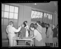 Leon C. Griest and Zella Rick taking cultures from women inmates at Lincoln Heights jail during diphtheria epidemic in Los Angeles, Calif., 1948