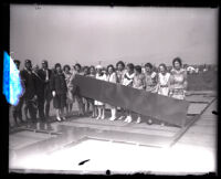 Women holding big "BEVERLY HILLS" sign at the La Cienega Blvd. waterworks, Beverly Hills, 1928
