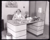 Coco Chanel sitting at a desk during visit to Los Angeles, 1931