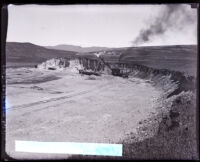 Steam shovel filling railway carts with dirt in empty Chatsworth Reservoir, Calif., circa 1930