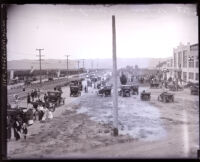Cars and people gathered at a commercial area, Van Nuys, circa 1920