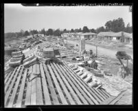 Workmen shingling roofs on new tract of three bedroom houses in Van Nuys, Calif., 1948