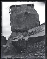 View from below, looking up at center portion of St. Francis Dam that remained after disaster, San Francesquito Canyon (Calif.), 1928