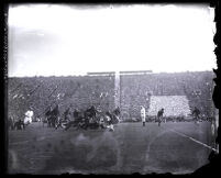 U.S.C. player breaking the tackle of a UC Berkeley opponent at the Coliseum, Los Angeles, 1927