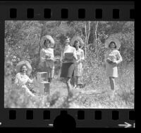 Five Las Candalistas members standing on trail, holding artifacts used for Walk on the Wild Side nature tours of Palos Verdes Peninsula, Calif., 1973