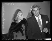 Gorgeous George Wagner with his wife Elizabeth (Betty) at court for name change in Los Angeles, Calif., 1950