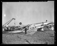 Emergency crews inspecting wreckage of plane crash at Los Angeles International Airport, Calif., circa 1953