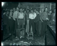 Male prisoners posing for camera in dining area at Wilshire police station, Los Angeles, circa 1920