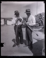 Policemen examining potential murder weapons at Northcott Chicken Ranch, Riverside, circa 1928