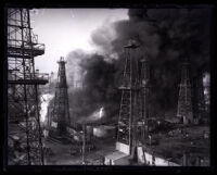 Plumes of smoke rising amid oil towers, Santa Fe Springs, 1929