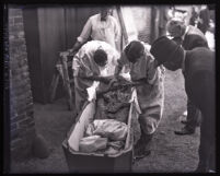 DO NOT PUBLISH - SENSITIVE - Los Angeles police examining the remains of murder victim Jacob C. Denton, Los Angeles, circa 1920