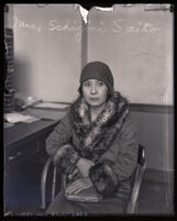 Japanese restaurant owner Mrs. Schigini Saito sitting in chair during questioning by police, Los Angeles, 1929