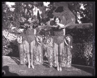Two girls in rose costumes beside float at the Tournament of Roses Parade, Pasadena, 1926