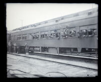 Marines from the 6th Regiment wave goodbye from a train car as they depart for China, Los Angeles, 1927