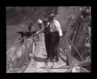 Henry W. Wright and J. W. Reagan on bridge looking down at Pacoima Dam site, Los Angeles County, 1926