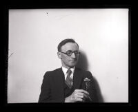 Dr. Thomas W. Young holding a flower, Los Angeles, 1925
