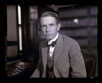 District attorney, Thomas Lee Woolwine, sitting in his office, Los Angeles, circa 1920