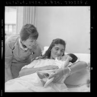 Midwife Wanda Mudler with mother and newborn at Los Angeles County-USC Medical Center, Calif., 1974