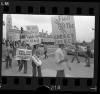 Demonstrators, one with sign reading "Fight the Energy Freeze" picketing against Exxon Corp. and oil prices in Los Angeles, Calif., 1974