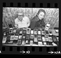 Martha Jordan and Mae Westbrook displaying an array of pocket calculators from their store, Electronic Emporium, in West Hollywood, Calif., 1974