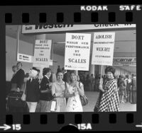 Western Airlines flight attendants with signs reading 