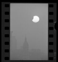 Partial eclipse of the sun seem above bell tower of St. Vibiana Cathedral in Los Angeles, Calif., 1974