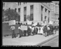 Pickets protesting "Hoovervilles" and supporting cooperative stores during hearing of California State Relief Administration, Los Angeles, 1940