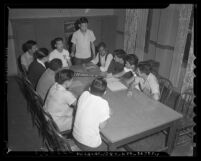 Group of eleven members of the Japanese YMCA holding meeting in Los Angeles, Calif. , circa 1941