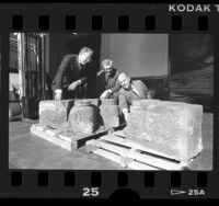 Rabbi Harvey J. Fields, Lionel Bell and Stephen E. Breuer inspecting unearthed carvings from synagogue in Los Angeles, Calif., 1988