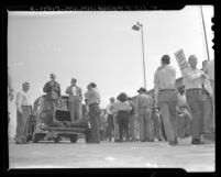 John Allard and Noah Tauscher with loudspeaker directing pickets in front of Chrysler Corp.'s plant in Maywood, Calif., 1948