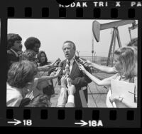 Senator Henry M. Jackson holding press conference near oil well in Inglewood, Calif., 1975