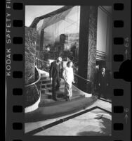 Betty Ford and Carey Grant descending staircase at Beverly Wilshire in Los Angeles, Calif., 1976