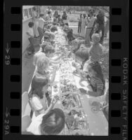 Children devouring 30-foot long banana split at Weymouth Science Center for bicentennial celebration, Calif., 1976