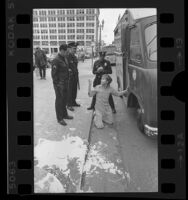 Skid Row resident covered in paint being questioned by police in Los Angeles, Calif., 1976