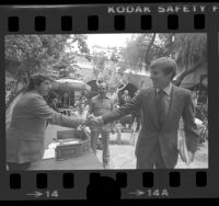 Tom Hayden and U.S. Senator John V. Tunney shaking hands at Los Angeles Press Club, Calif., 1976