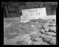 Sign on produce stand reading "This is all there is until we lick the Japs", food rationing in 1942 Los Angeles, Calif.
