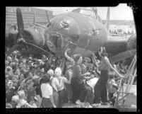 Women aircraft workers signing their names on the B-17 bomber, Memphis Belle in Long Beach, Calif.