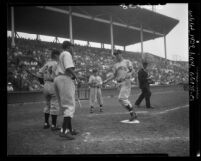Les Layton, Jess Dobernic and Gene Baker at home plate during Hollywood Stars vs Los Angeles Angels game, 1950