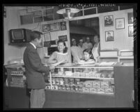 Mrs. Joe Woo welcomes customer to her husband's Chinese restaurant in North Hollywood, Calif., 1959