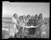 Group portrait of eight women pilots before they leave Palm Springs for 1948 Powder Puff Derby