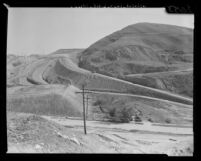 One of 12 remaining homes cut off by land grading in preparation for Los Angeles Dodgers' Chavez Ravine ball park, 1960