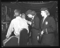 Policewomen Chloe Elwood and Janet Elvedahl checking IDs in a bar in Los Angeles, Calif., 1948