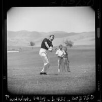 James Garner, TV's "Maverick," hits fine iron shot to reach ninth green in Yorba Linda, Calif., 1960