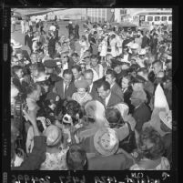 Presidential nominee Richard Nixon and his wife Pat are hemmed in by a crowd of well-wishers in 1960, Los Angeles, Calif.
