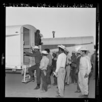 Plights of Americans and Braceros Compared:Mexican nationals board bus at labor camp in Long Beach, Calif., 1961