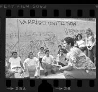 Ray Torres of Victory Outreach program speaking with youths in East Los Angeles, 1976