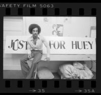 Huey P. Newton with sign that reads "Justice For Huey," 1977
