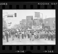 Demonstrators, with banners in Spanish, marching in protest to President Jimmy Carter's undocumented immigrant program, East Los Angeles, 1977