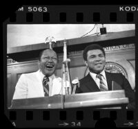 Mayor Tom Bradley and Muhammad Ali at podium in Los Angeles City Hall, 1979