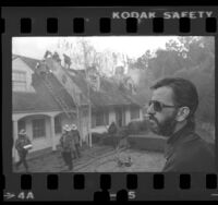 Ringo Starr watching firemen extinguish fire at his house Hollywood, Calif., 1979